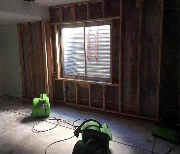 room of house with SERVPRO drying equipment at work