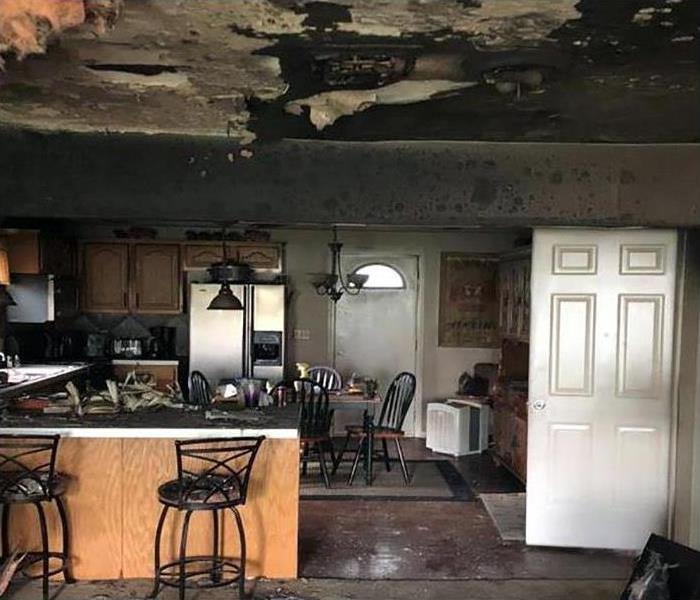 kitchen and living room covered in soot by fire