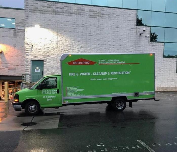 SERVPRO truck parked in front of a flood damaged commercial facility